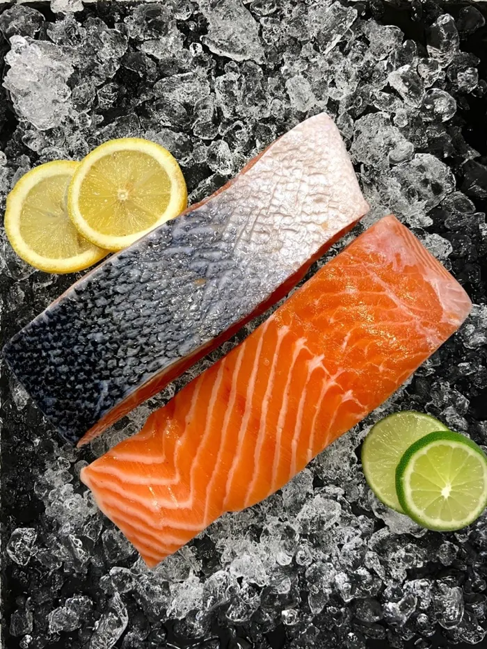 Salmon fillet on ice with lemon and lime
